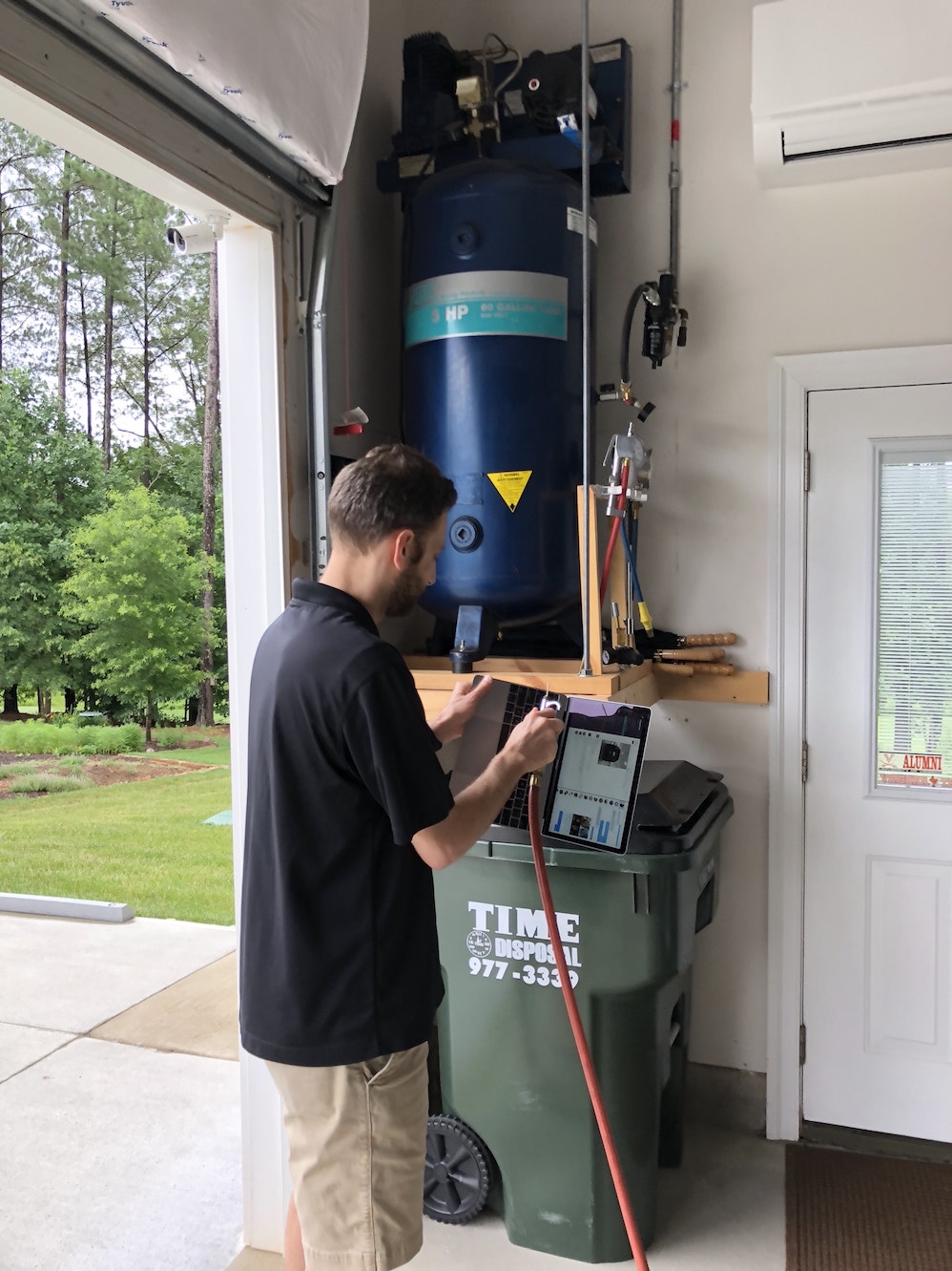 Me using a garage air compressor to blow out my MacBook keyboard