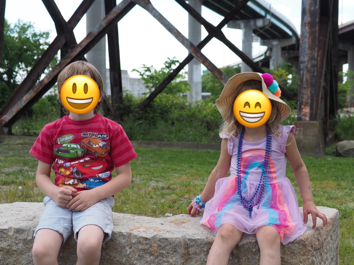 My kids, with emoji in front of their faces.