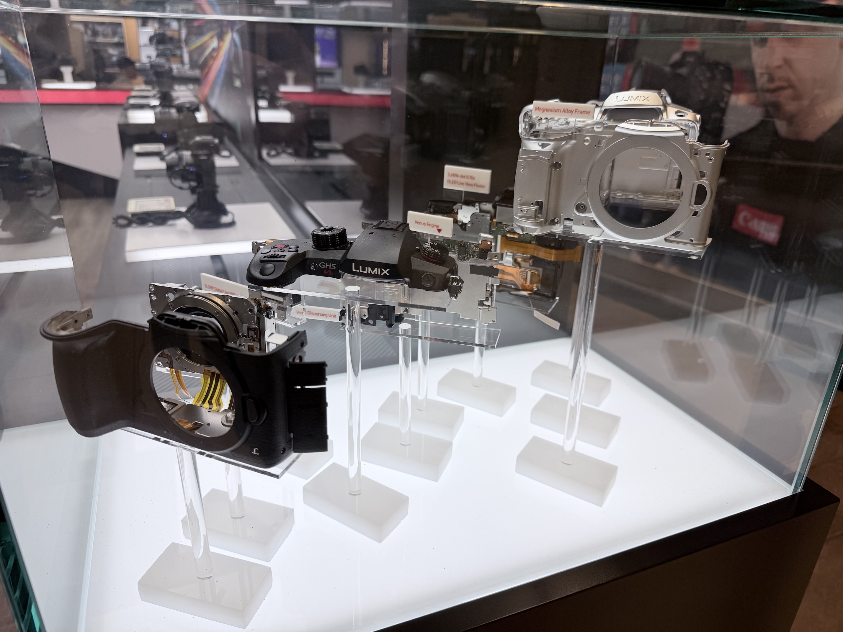 Display case showing an exploded Panasonic camera.