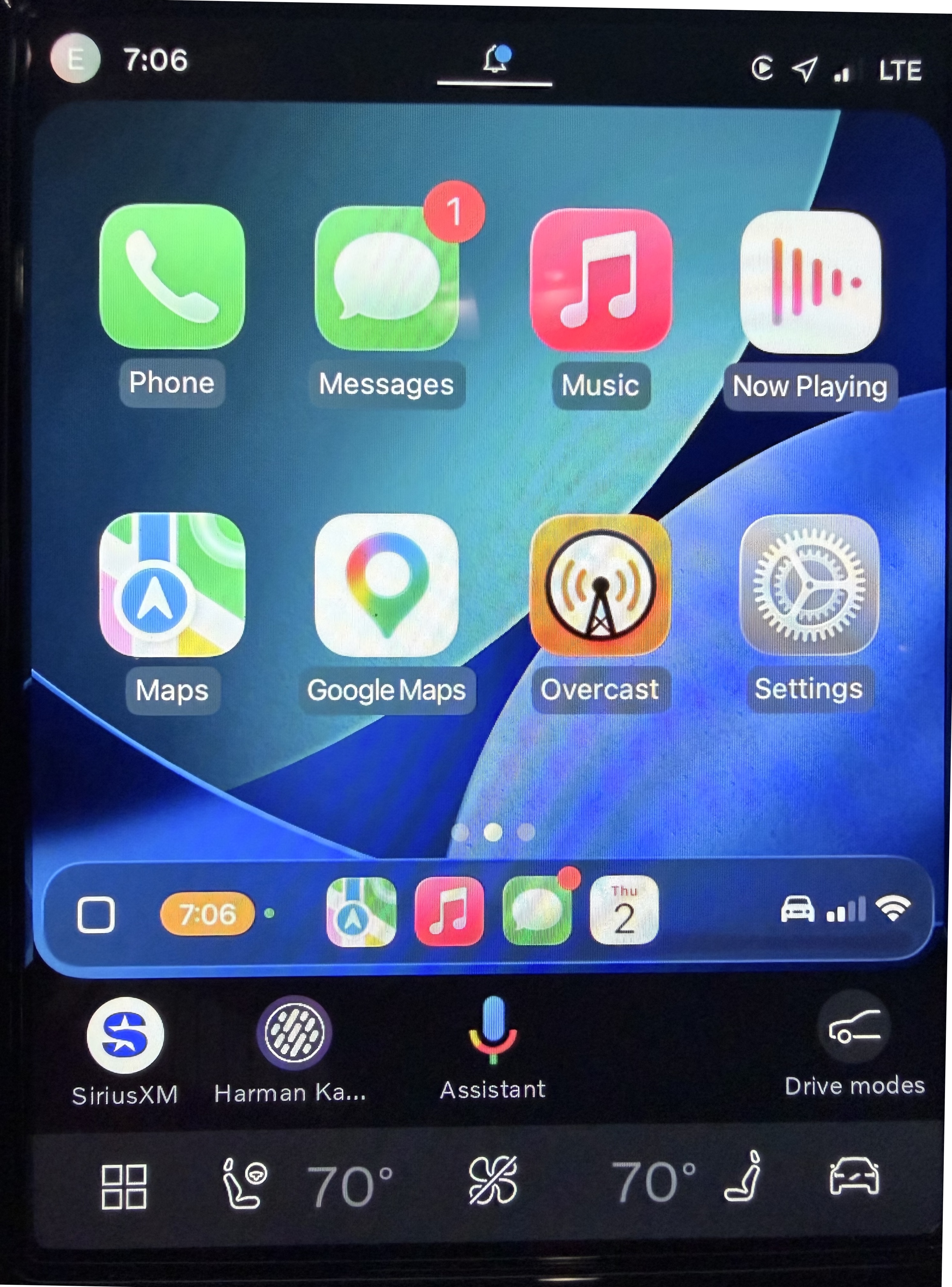 Photo of an infotainment screen showing CarPlay on the top 80% of the screen, and Volvo UI below it.