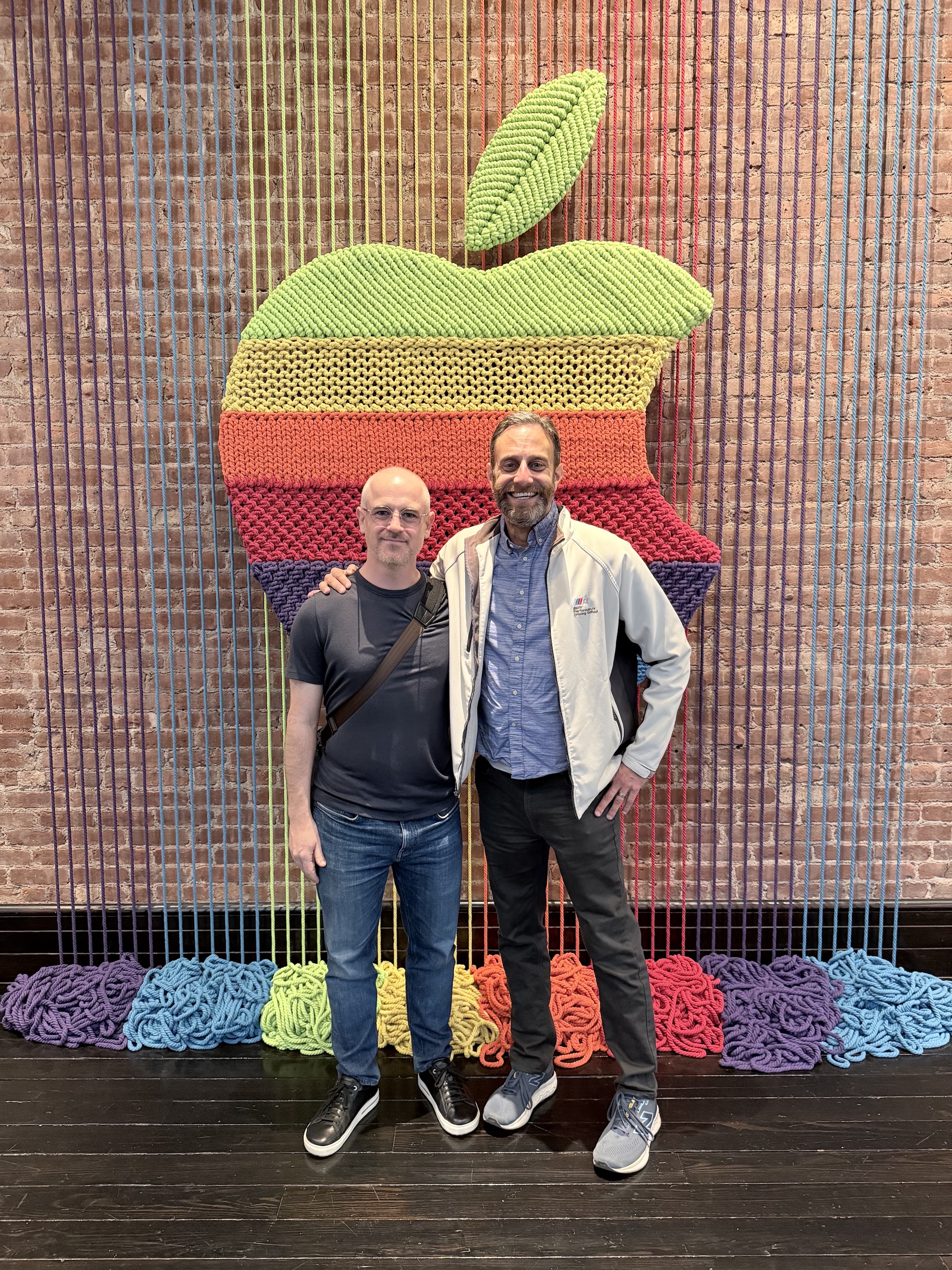 Marco and me standing in front of a six color Apple woven out of yarn